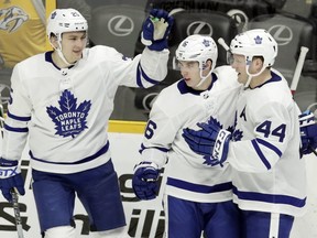 Toronto Maple Leafs center Mitchell Marner (16) is congratulated by James van Riemsdyk (25) and Morgan Rielly (44) after Marner scored against the Nashville Predators in the third period of an NHL hockey game Thursday, March 22, 2018, in Nashville, Tenn.
