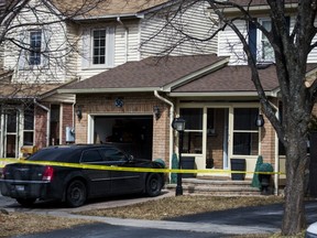 Police tape marks off the home where a woman and her two teenaged children were killed. (ERNEST DOROSZUK, Toronto Sun)