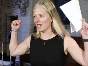 Environment and Climate Change Minister Catherine McKenna raises her arms to cheer for the Ottawa Senators hockey team on May 18, 2017. THE CANADIAN PRESS