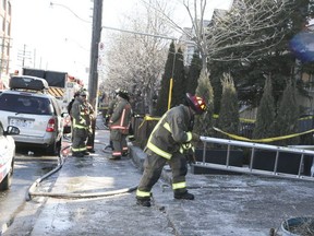 Toronto firefighters are pictured at the scene of a blaze on Dupont St. (VERONICA HENRI, Toronto Sun)