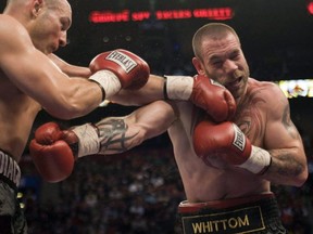 Canadian fighter David Whittom, right, takes a shot during a fight. The boxer has died after almost a year in a coma.