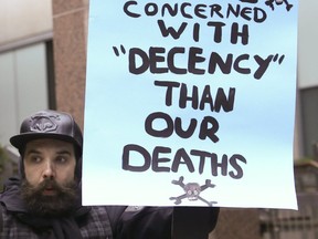 Protesters outside of police headquarters on College St. on March 22, 2018. (Veronica Henri, Toronto Sun)