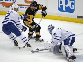 Toronto Maple Leafs goaltender Frederik Andersen (31) stops a shot by Pittsburgh Penguins' Phil Kessel (81) with Patrick Marleau (12) defending during the third period of an NHL hockey game in Pittsburgh, Saturday, Feb. 17, 2018. The Penguins won 5-3.