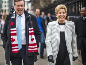 Toronto Mayor John Tory and Ontario Premier Kathleen Wynne walk along Queen St. W. to City Hall for a meeting.   (Ernest Doroszuk,Toronto Sun)