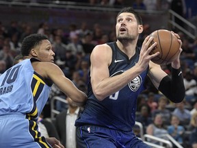 Orlando Magic centre Nikola Vucevic sets up to shoot in front of Memphis Grizzlies' Ivan Rabb earlier this month. (AP PHOTO)