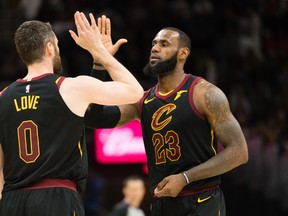 Cleveland Cavaliers' Kevin Love (left) celebrates with LeBron James against the Milwaukee Bucks on Monday. (GETTY IMAGES)