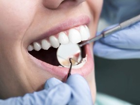 A woman gets her teeth checked.