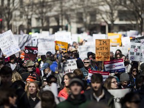 Demonstrators hold signs at the start of the March for Our Lives rally March 24, 2018 in Washington, DC. Hundreds of thousands of demonstrators, including students, teachers, and parents are expected to gather for the anti-gun violence rally, spurred largely by the shooting that took place on Valentine's Day at Marjory Stoneman Douglas High School in Parkland, Florida where 17 people died.  (Photo by Zach Gibson/Getty Images)