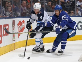 Andrew Copp #9 of the Winnipeg Jets skates against Nikita Zaitsev #22 of the Toronto Maple Leafs during an NHL game at the Air Canada Centre on March 31, 2018 in Toronto, Ontario, Canada.