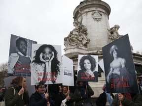 Demonstrators hold placards depicting famous women on the place de la Republique in Paris on March 8, 2018 during a demonstration called by feminists association to mark International Women's Day.