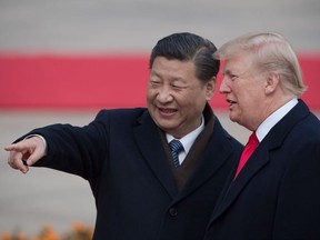 In this file photo taken on November 8, 2017 China's President Xi Jinping (L) and US President Donald Trump attend a welcome ceremony at the Great Hall of the People in Beijing.