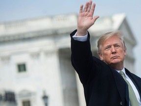 US President Donald Trump waves after the annual Friends of Ireland luncheon at the US Capitol in Washington, DC, March 15, 2018.
