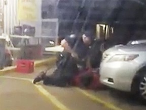In this July 5, 2016 photo made from video, Alton Sterling is held by two Baton Rouge police officers, with one holding a hand gun, outside a convenience store in Baton Rouge, La. Moments later, one of the officers shot and killed Sterling.