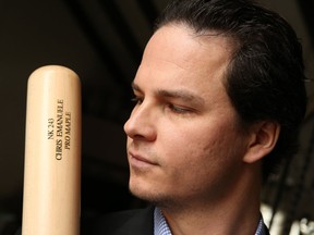 Ex-Toronto Blue Jays prospect Chris Emanuele, whose career ended due to a flesh-eating disease in 2011, looks at one of his bats on March 7, 2018