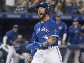Toronto Blue Jays' Kevin Pillar reacts after stealing home for the Jays fifth run in the eighth inning of their American League MLB baseball game against the New York Yankees, in Toronto on Saturday, March 31, 2018.