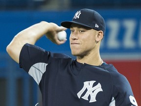Yankees right fielder Aaron Judge throws the ball as he takes part in batting practice yesterday ahead of the season opener at the Rogers Centre.  THE CANADIAN PRESS/Nathan Denette