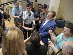 Patriots head coach Bill Belichick, right, answers a question from a reporter at the coaches breakfast during the NFL owners meetings, Tuesday, March 27, 2018 in Orlando, Fla. (Phelan M. Ebenhack/AP Images for NFL)