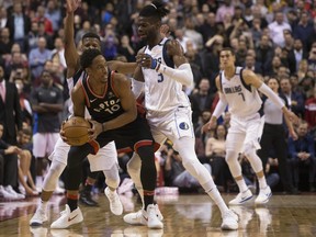 Toronto Raptors guard DeMar DeRozan (10) shields the ball from Dallas Mavericks guard Dennis Smith Jr. (1) and centre Nerlens Noel (3) during overtime  in Toronto on Friday.THE CANADIAN PRESS/Chris Young ORG XMIT: CHY115