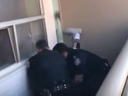 Screenshot of Toronto Police officers arresting a man on a balcony in Scarborough.