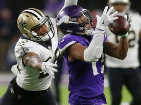 In this Jan. 14, 2018, file photo, then-Minnesota Vikings wide receiver Jarius Wright (17) makes a catch in front of New Orleans Saints cornerback P.J. Williams
