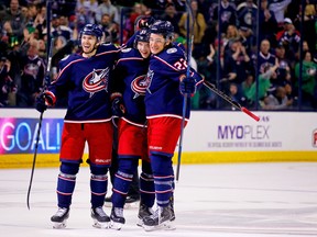 Markus Nutivaara of the Columbus Blue Jackets is congratulated by Oliver Bjorkstrand and Sonny Milano after scoring against the Ottawa Senators on March 17, 2018