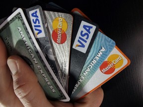 In this file photo, consumer credit cards are posed in North Andover, Mass., on March 5, 2012.