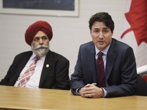 Prime Minister Justin Trudeau speaks at a roundtable on Employment insurance while MP Darshan Kang looks on at the Kerby Centre on Tuesday March 29, 2016 in Calgary, AB.