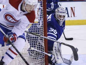 Maple Leafs goaltender Curtis McElhinney guards the post against Canadiens forward Artturi Lehkonen ) during second period NHL action in Toronto on Saturday, March 17, 2018.