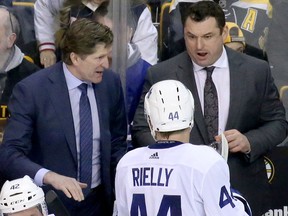 Mike Babcock and DJ Smith chat with Morgan Rielly during a Maple Leafs-Bruins game on Feb. 3, 2018