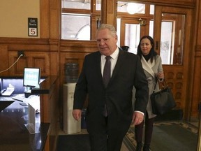 Ontario PC leader Doug Ford arrives at Queen's park and is swarmed by media before a caucus meeting on Tuesday March 20, 2018.