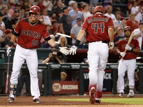 Jake Lamb (22) and Paul Goldschmidt of the Diamondbacks could wind up with fewer high-five opportunities with Chase Field storing its baseballs in humidors. (Photo by Christian Petersen/Getty Images)