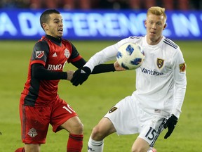 Sebastian Giovinco of Toronto FC battles for the ball against Justen Glad of Real Salt Lake Friday night. (Dave Abel/Toronto Sun)