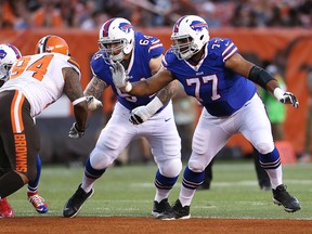 In this Aug. 20, 2015, file photo, Buffalo Bills tackle Cordy Glenn (77) and Richie Incognito (64) work against Cleveland Browns defensive tackle Randy Starks (94) during an NFL preseason football game,  in Cleveland. Cordy Glenn has signed his $13.7 million franchise tender, the player's representatives have announced on their Twitter account. Glenn signed the one-year offer on Friday, three days after the Bills designated him as their franchise player.  (AP Photo/Ron Schwane, File) ORG XMIT: NY176