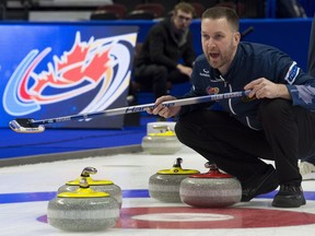 Skip Brad Gushue, of St. John's, Nfld. calls to sweepers as a rock approaches the house during Olympic curling trials action Monday December 4, 2017 in Ottawa. THE CANADIAN PRESS/Adrian Wyld