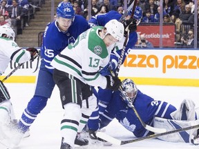 Dallas Stars centre Mattias Janmark (13) and Toronto Maple Leafs left wing James van Riemsdyk (25) battle for the puck in front of Maple Leafs goaltender Frederik Andersen (31) during first period NHL hockey action in Toronto on Wednesday, March 14, 2018. THE CANADIAN PRESS/Chris Young ORG XMIT: CHY103