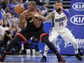 Toronto Raptors' Serge Ibaka, left, loses his grip on the ball as the Orlando Magic's D.J. Augustin (14) defends Wednesday, Feb. 28, 2018, in Orlando, Fla. (AP Photo/John Raoux)