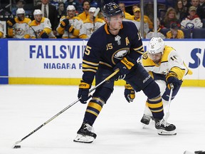 Buffalo Sabres forward Jack Eichel (15) carries the puck past Nashville Predators Mike Fisher (12) Monday, March 19, 2018, in Buffalo, N.Y. (AP Photo/Jeffrey T. Barnes)