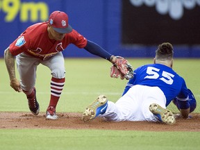 Toronto Blue Jays catcher Russell Martin (55) slides in with a double ahead of the tag by St. Louis Cardinals second baseman Kolten Wong (16) during spring training action on Monday, March 26, 2018 in Montreal. (THE CANADIAN PRESS/Ryan Remiorz)