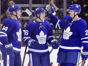 Toronto Maple Leafs centre Mitch Marner (16) celebrates with defencemen Morgan Rielly (44) and Ron Hainsey (2) after scoring against the Florida Panthers in Toronto on Wednesday, March 28, 2018. (THE CANADIAN PRESS/Frank Gunn)