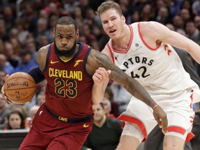 Cleveland Cavaliers' LeBron James drives past Toronto Raptors' Jakob Poeltl during an NBA game on March 21, 2018