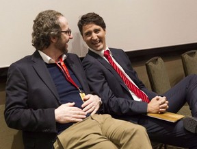 Prime Minister Justin Trudeau, right, chats to his chief advisor Gerald Butts after taking part in the Liberal leadership debate in Mississauga, Ont., on Feb. 16, 2013. THE CANADIAN PRESS