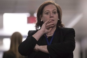 PC MPP Lisa MacLeod stands in a hallway during confusion about the result at the Ontario PC Leadership announcement in Markham, Ont., on Saturday, March 10, 2018.