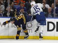 Maple Leafs forward Matt Martin (right) collides with Sabres defenceman Casey Nelson in Buffalo on Monday night. (The Associated Press)