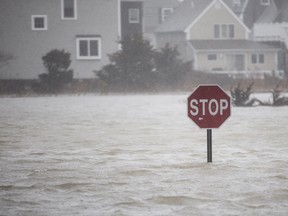 A flooded out road with a stop sign as a large coastal storm bears down on the region on March 2, 2018 in Scituate, Massachusetts. (Scott Eisen/Getty Images)