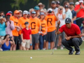In this March 11, 2018, file photo, Tiger Woods lines up a putt on the 13th hole during the final round of the Valspar Championship golf tournament, in Palm Harbor, Fla. The buzz following Woods since his return from a fourth back surgery has been bigger and louder than when he was No. 1 in the world, piling up 79 victories on the PGA Tour and 14 majors.