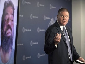 Toronto Police Det. Hank Idsinga, lead investigator in the case against alleged serial killer Bruce McArthur, stands with a photo of an unidentified man, suspected of being another of McArthur's victims, during a news conference at Toronto Police headquarters on Monday, March 5, 2018. THE CANADIAN PRESS/Chris Young