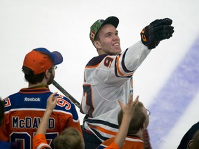 Connor McDavid throws a hat to fans after taking part in the Edmonton Oilers skills competition on Feb. 3, 2018
