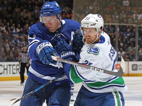 Daniel Sedin of the Vancouver Canucks tries to shove his way past Morgan Rielly of the Toronto Maple Leafs at the Air Canada Centre in Toronto January 6, 2018. (Claus Andersen/Getty Images)