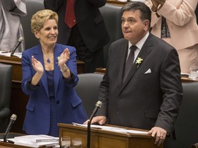 Ontario's Premier Kathleen Wynne applauds Provincial Finance Minister Charles Sousa as the Ontario Provincial Government delivers its 2018 Budget , at the Queens Park Legislature in Toronto, on Wednesday March 28, 2018.