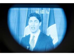Prime Minister Justin Trudeau is seen through the eye piece of a television camera, as he takes questions from the media after addressing the UPS Conference in Toronto on March 21, 2018.